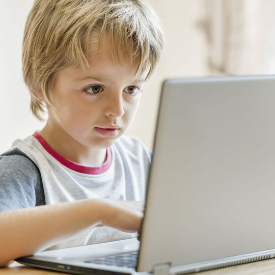 young-boy-working-on-laptop